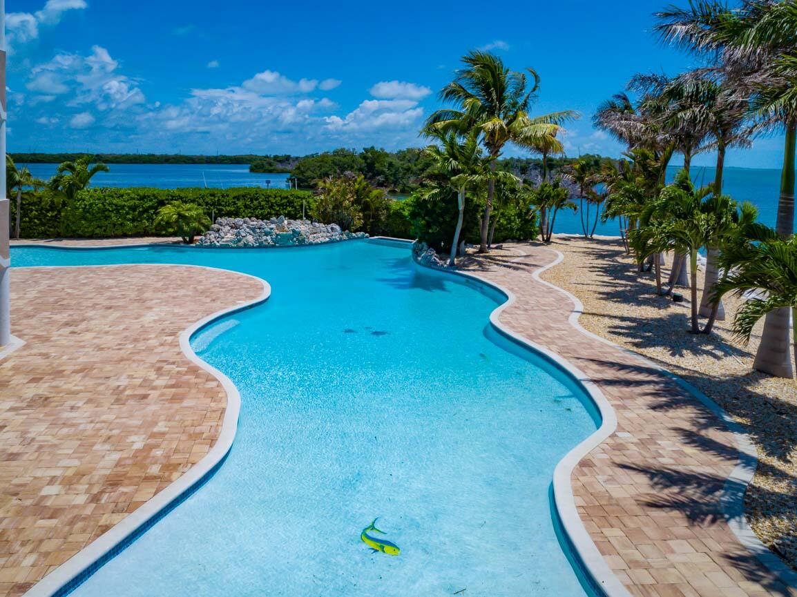 2480 Coco Plum Drive Marathon, FL 33050 - Photo 4 of 92 a view of a garden with a fountain