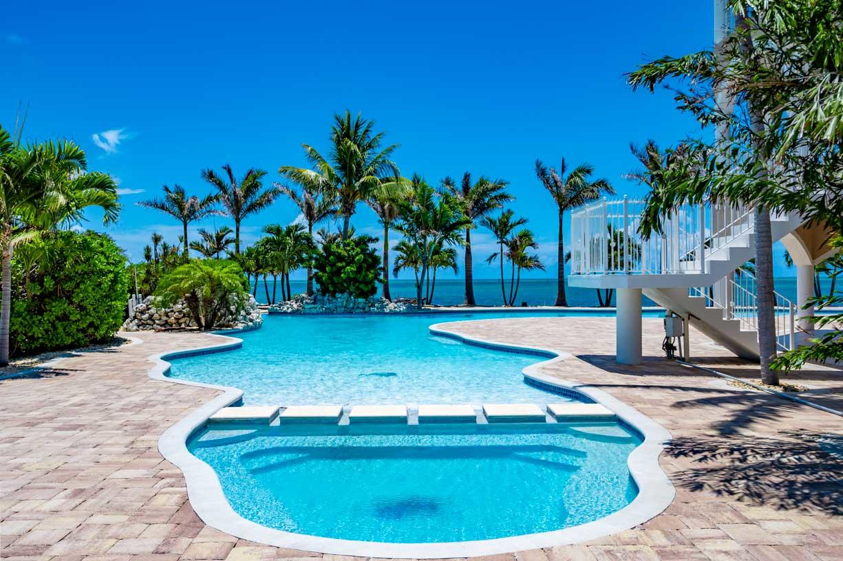 2480 Coco Plum Drive Marathon, FL 33050 - Photo 5 of 92 a view of a swimming pool with a sitting space
