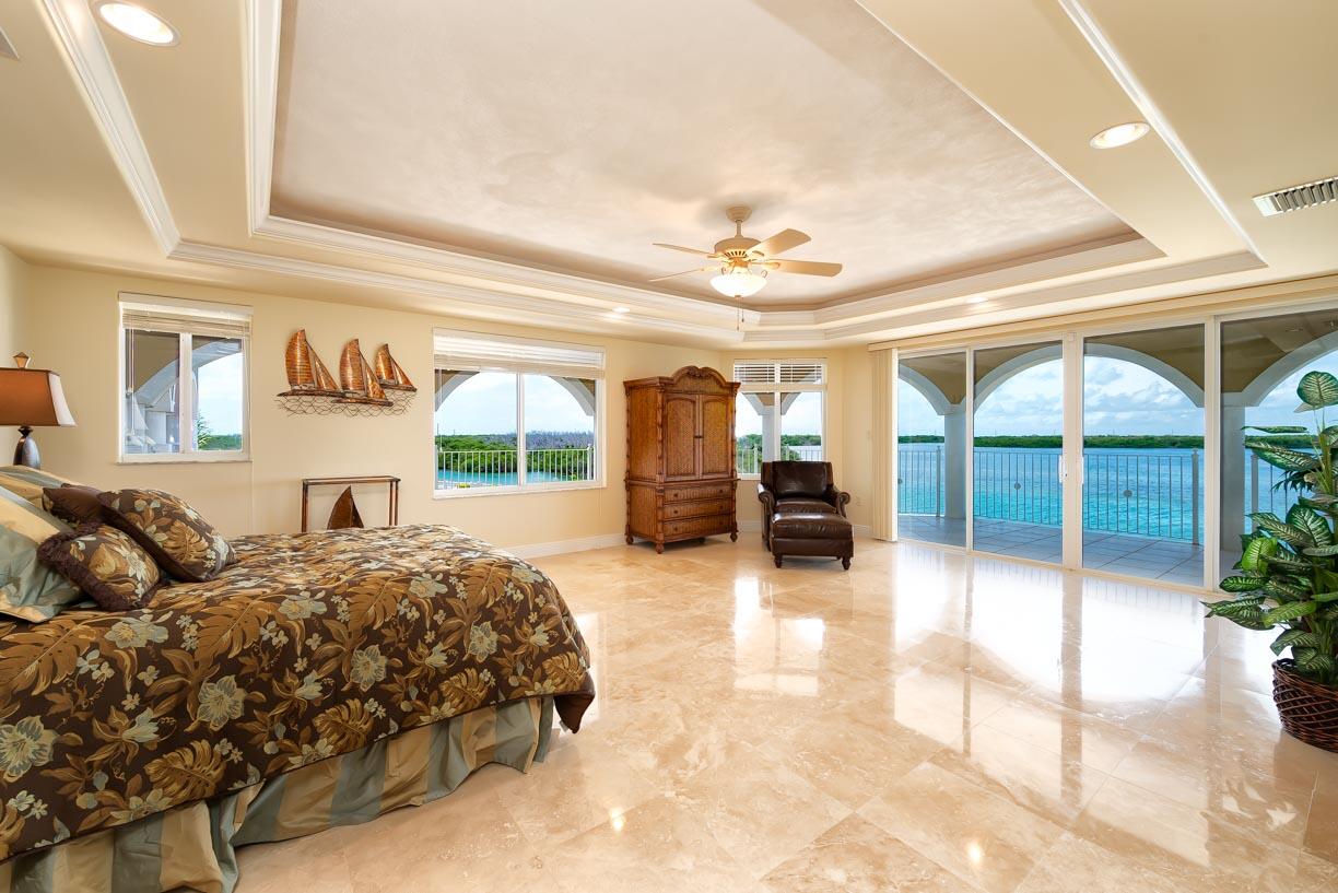 2480 Coco Plum Drive Marathon, FL 33050 - Photo 42 of 92 a bedroom with a large bed and a large window with outer view