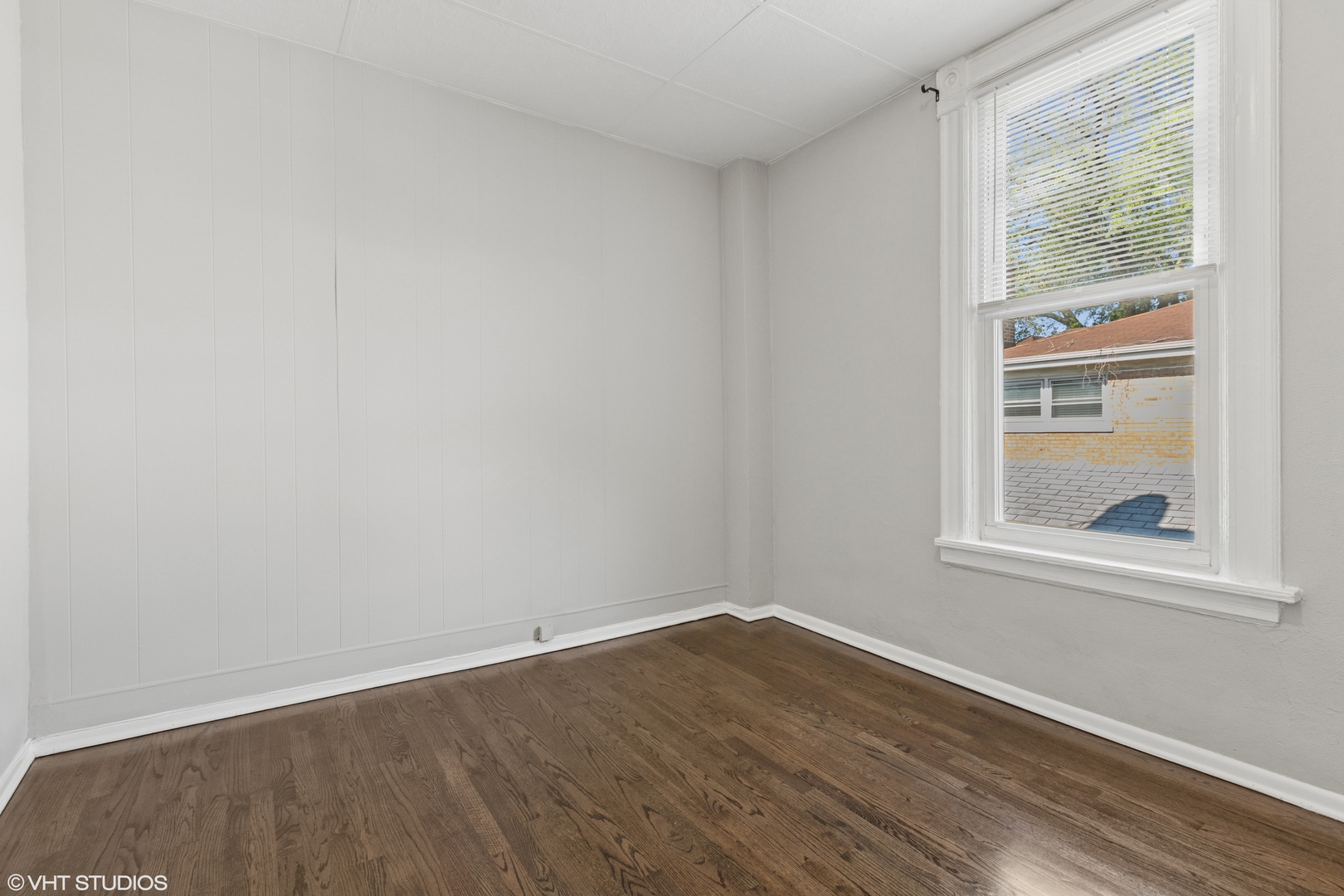 2335 West School Street Chicago, IL 60618 - Photo 12 of 23 an empty room with wooden floor and windows