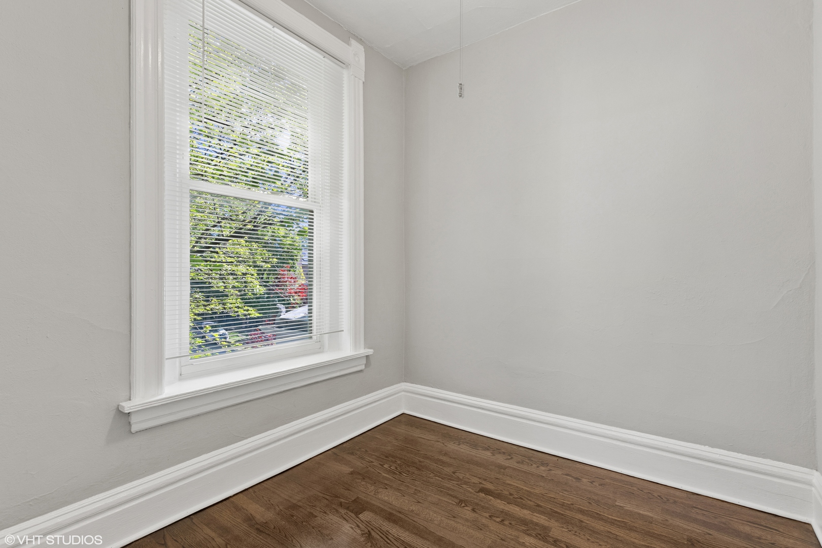 2335 West School Street Chicago, IL 60618 - Photo 15 of 23 a view of an empty room with wooden floor and a window