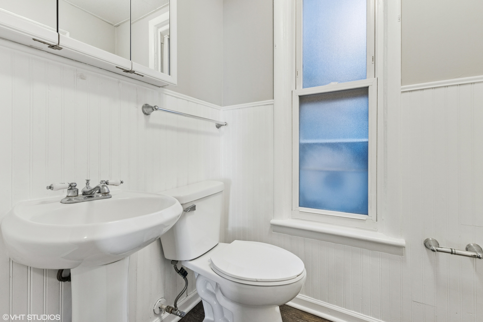 2335 West School Street Chicago, IL 60618 - Photo 17 of 23 a bathroom with a sink toilet and a mirror