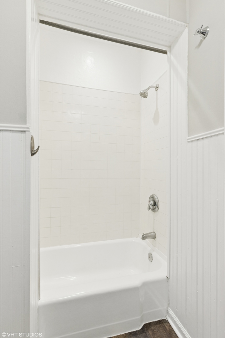 2335 West School Street Chicago, IL 60618 - Photo 18 of 23 a bathroom with a shower and a bath tub