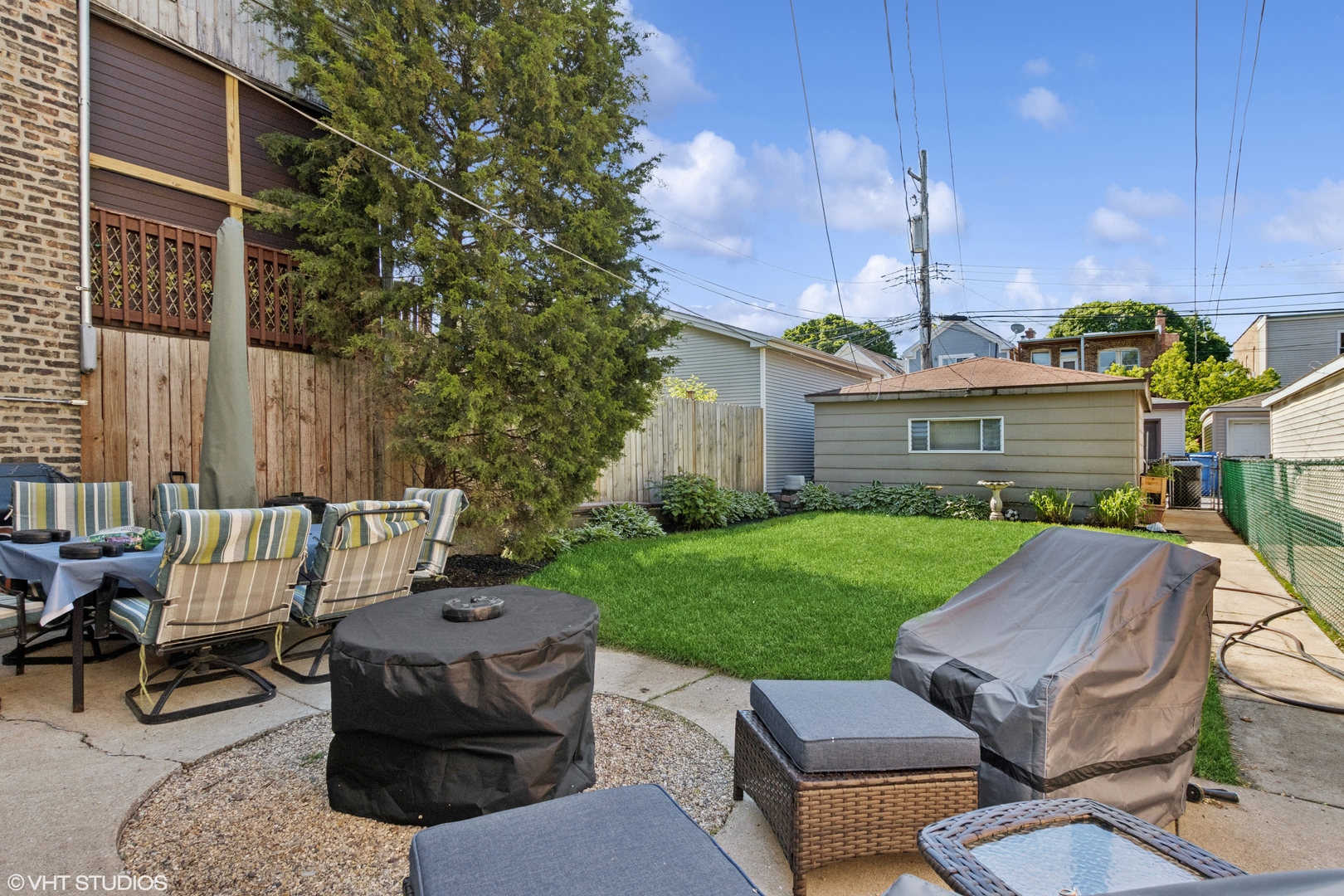 2335 West School Street Chicago, IL 60618 - Photo 23 of 23 a view of a patio with a table chairs and a fire pit