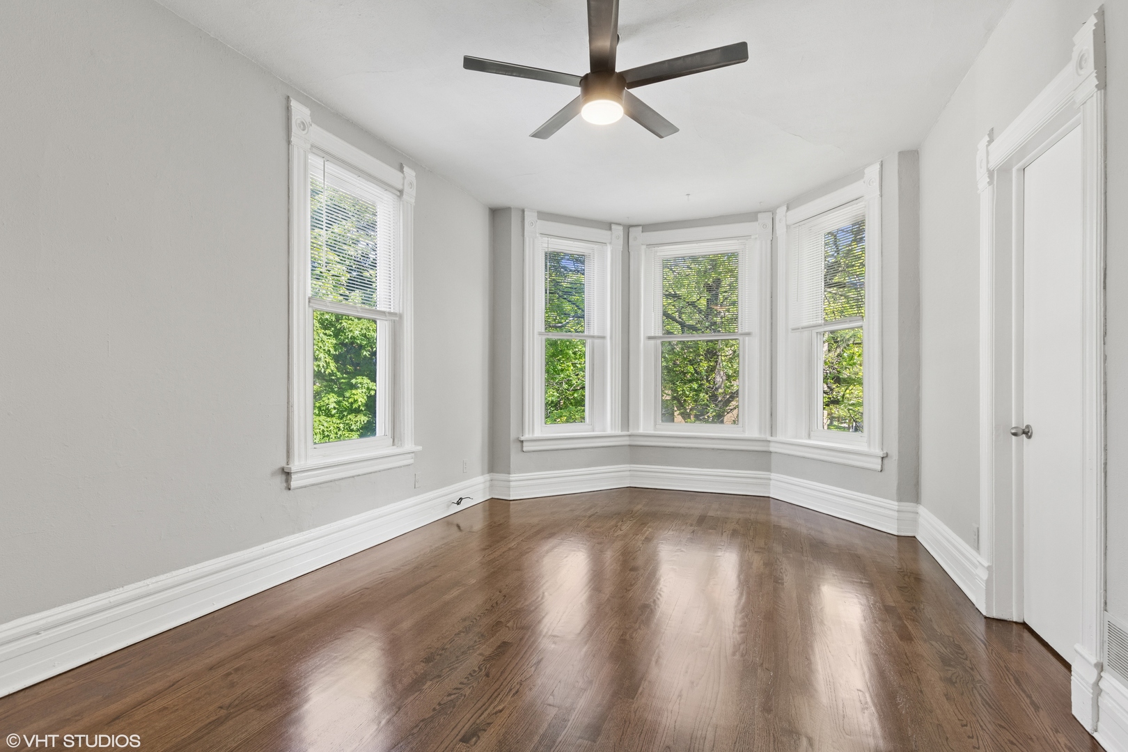 2335 West School Street Chicago, IL 60618 - Photo 3 of 23 a view of empty room with wooden floor and fan