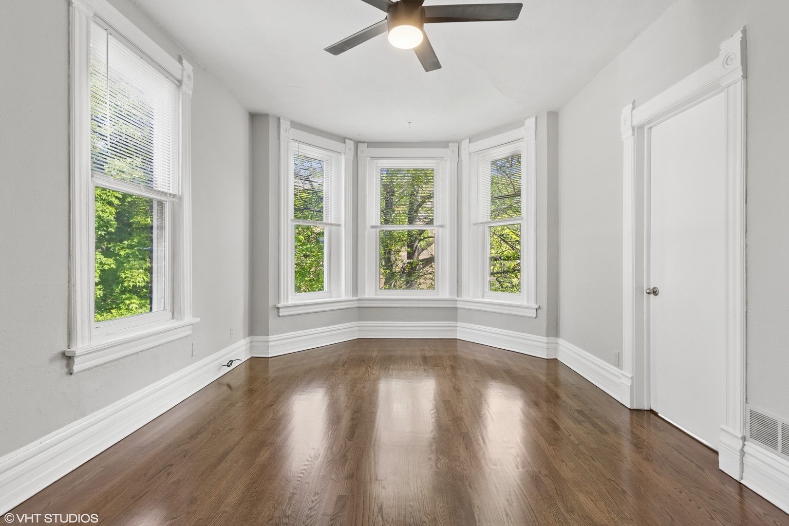 2335 West School Street Chicago, IL 60618 - Photo 4 of 23 a view of an empty room with wooden floor and a window