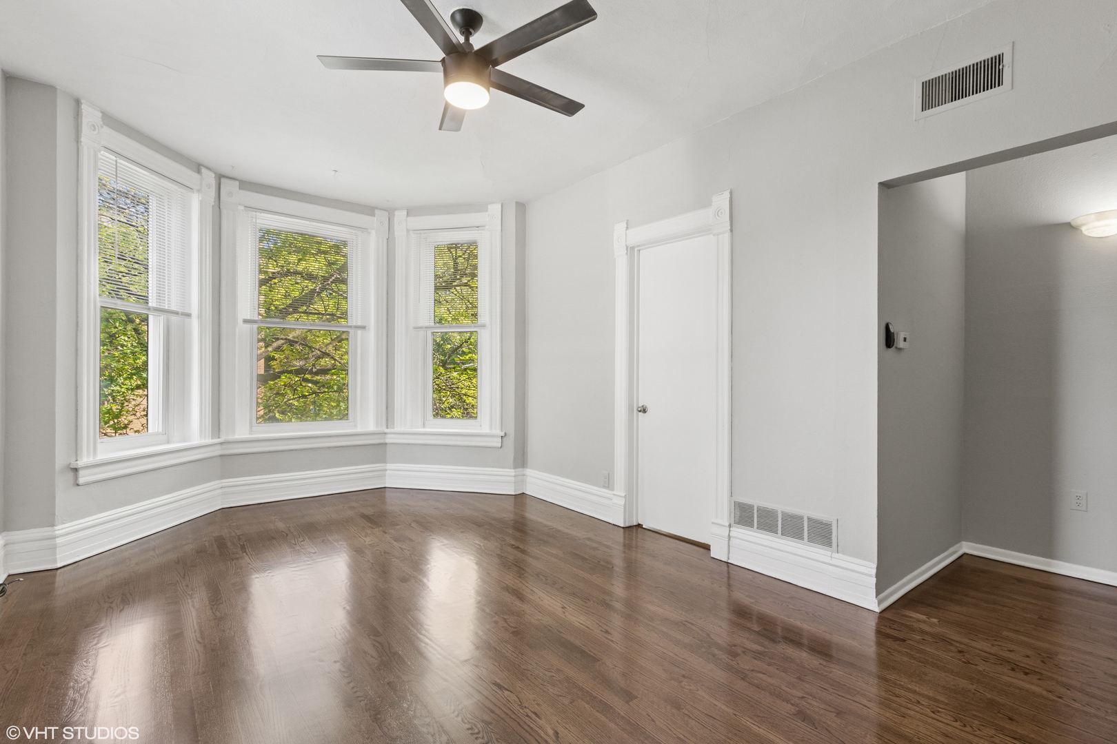 2335 West School Street Chicago, IL 60618 - Photo 5 of 23 a view of an empty room with wooden floor and a window