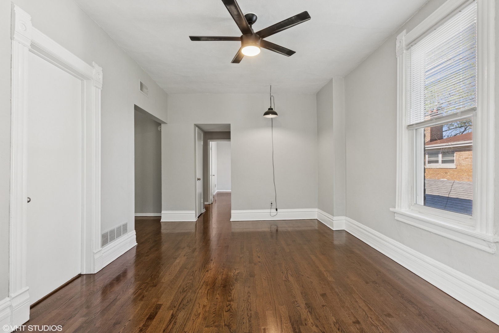 2335 West School Street Chicago, IL 60618 - Photo 6 of 23 a view of an empty room with window and wooden floor
