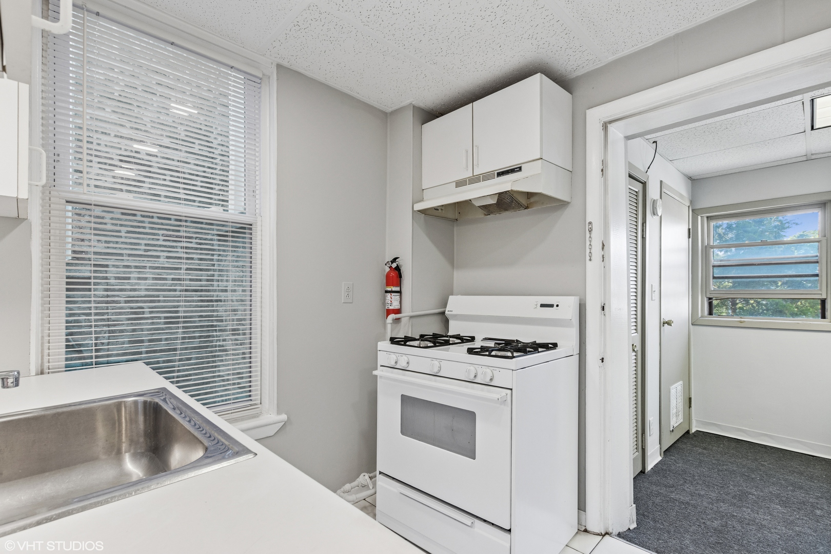 2335 West School Street Chicago, IL 60618 - Photo 10 of 23 a kitchen with white cabinets and white appliances