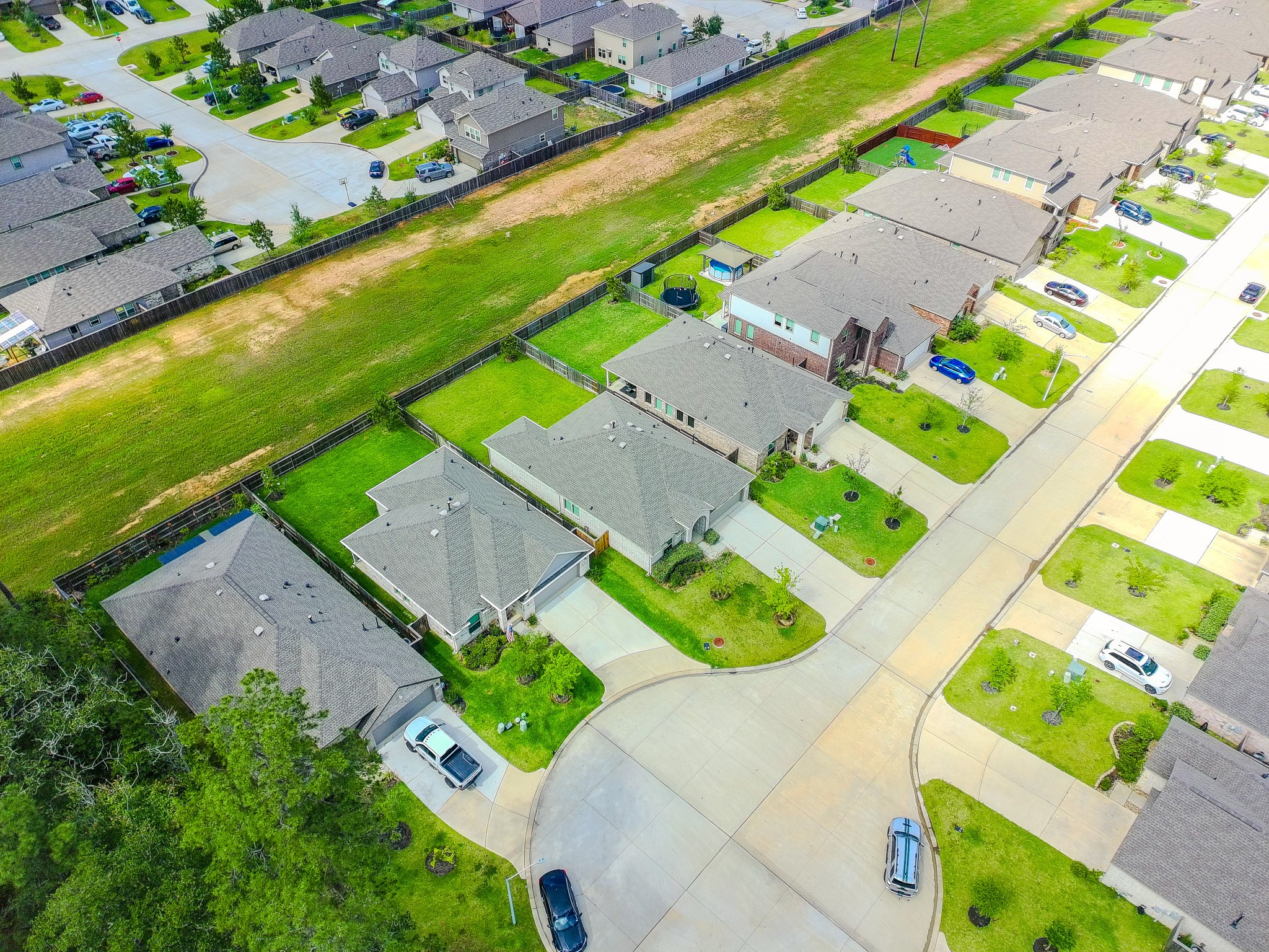 3113 Catalonion Court Conroe, TX 77301 - Photo 33 of 45 an aerial view of a house with a garden and swimming pool
