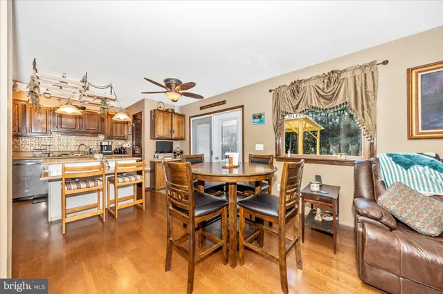 a dining room with furniture and wooden floor