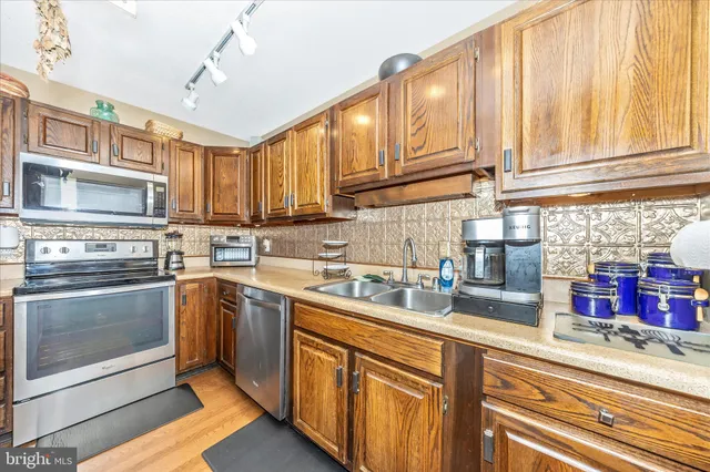 a kitchen with stainless steel appliances granite countertop a sink and cabinets