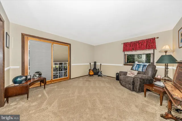 a living room with furniture and large windows