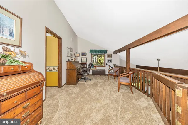 a view of staircase with furniture and a window