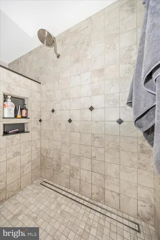 a bedroom with a bed dresser and window