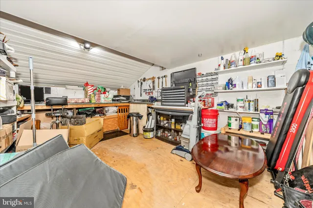 a view of a white house with a large trees and yard