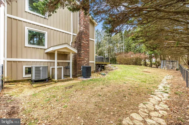 a view of a patio with table and chairs and wooden fence