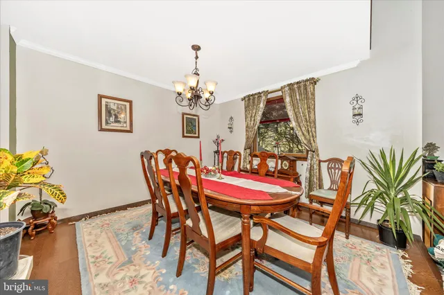 a view of a dining room with furniture and chandelier