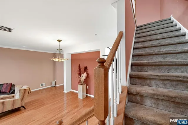 a view of entryway and hall with wooden floor