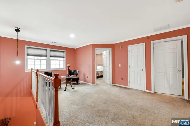 a view of a livingroom with furniture window and a kitchen