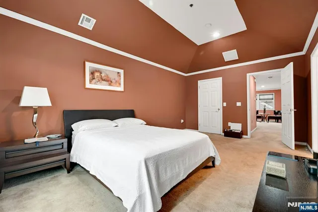 a bedroom with a bed and a lamp on table