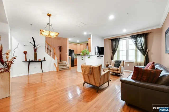 a living room with furniture and a chandelier