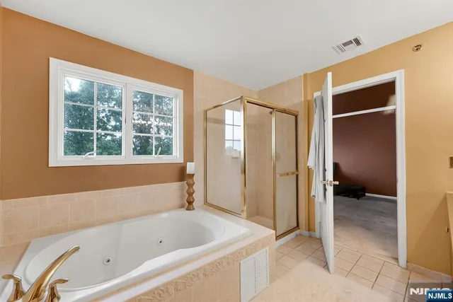 a bathroom with a tub shower and sink