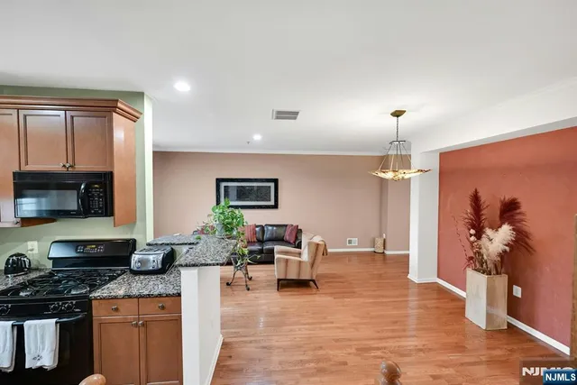 a living room with furniture a flat screen tv and a lamp
