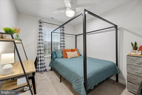 a bedroom with a bed next to a window