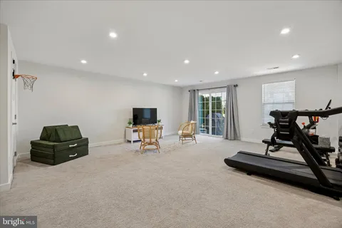 a living room with furniture gym equipment and a window