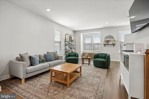 a living room with furniture a rug and a window