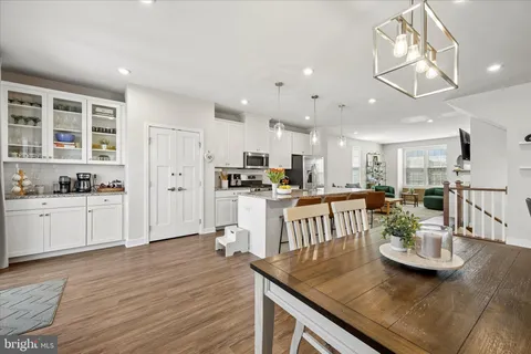 a kitchen with kitchen island granite countertop lots of counter top space and stainless steel appliances