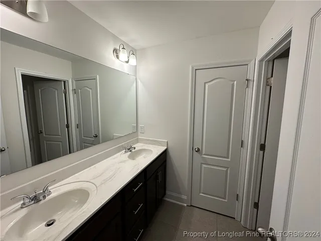a bathroom with a double vanity sink mirror and double