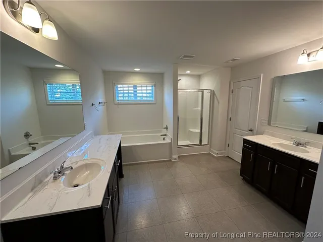a bathroom with a sink double vanity and a mirror