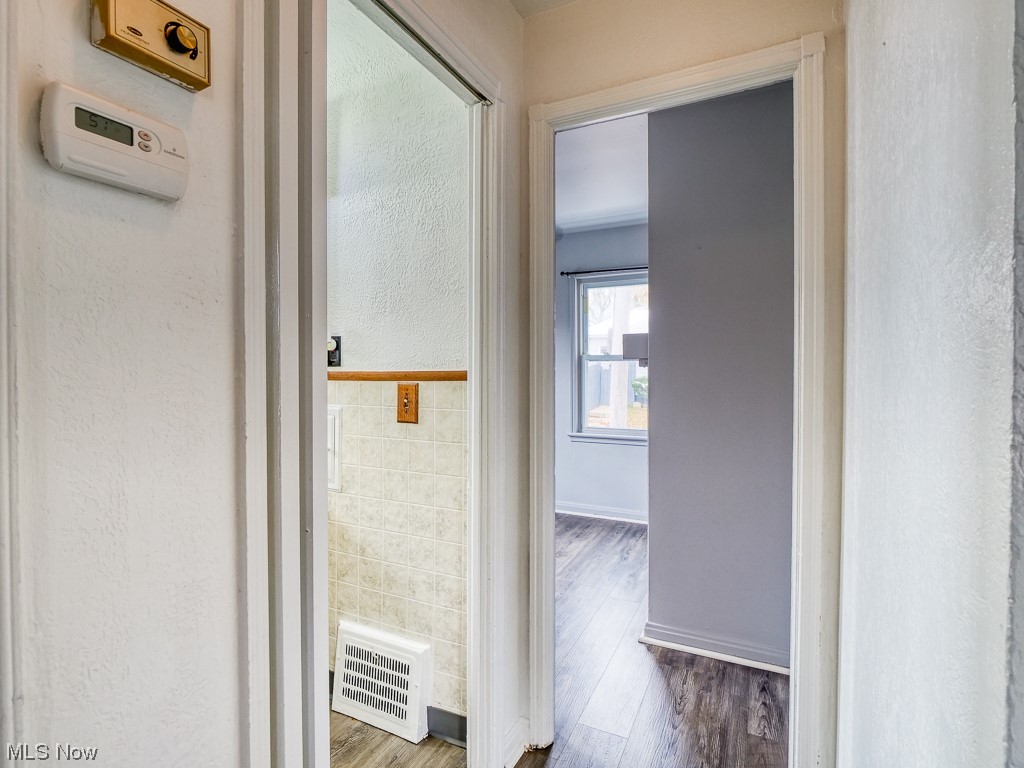 3774 Highland Road Cleveland, OH 44111 - Photo 14 of 31 Corridor with hardwood / wood-style flooring and tile walls