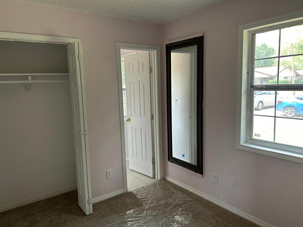 10034 Mill Valley Lane Dallas, TX 75217 - Photo 15 of 18 an empty room with windows