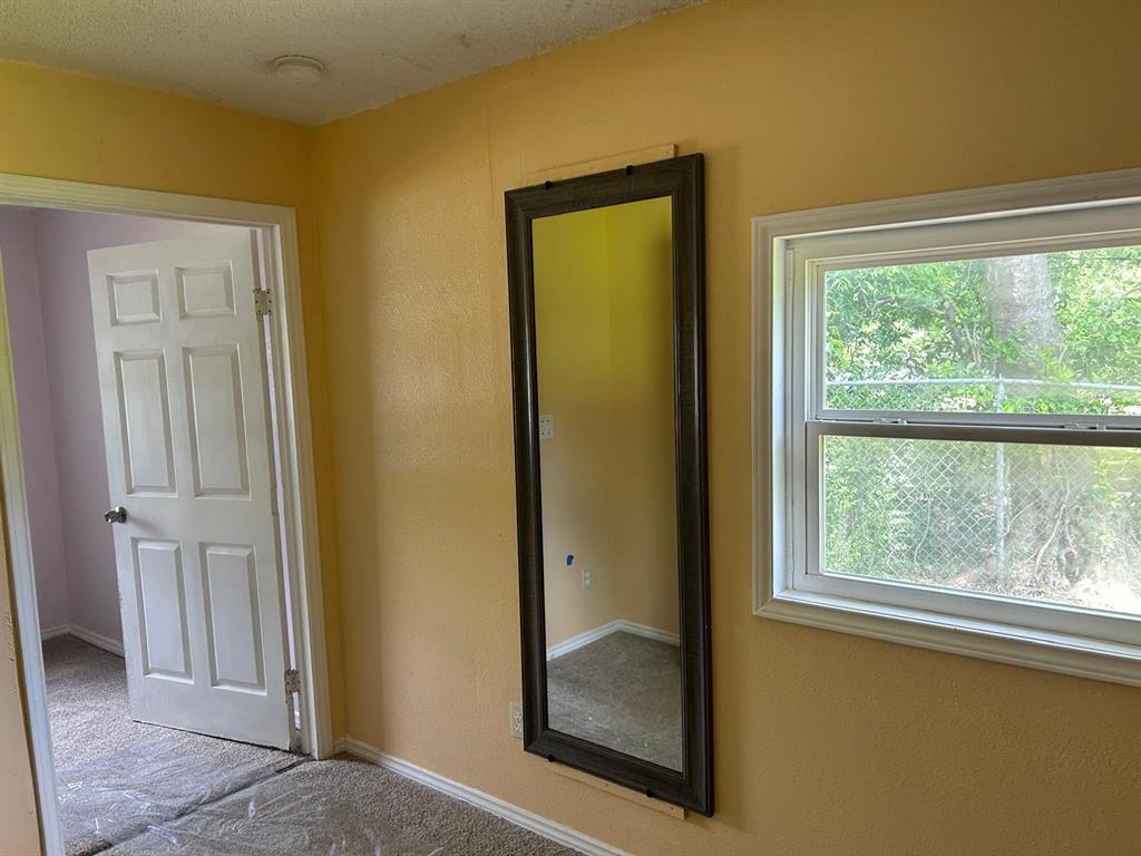 10034 Mill Valley Lane Dallas, TX 75217 - Photo 16 of 18 a view of a hallway with a glass door and a window