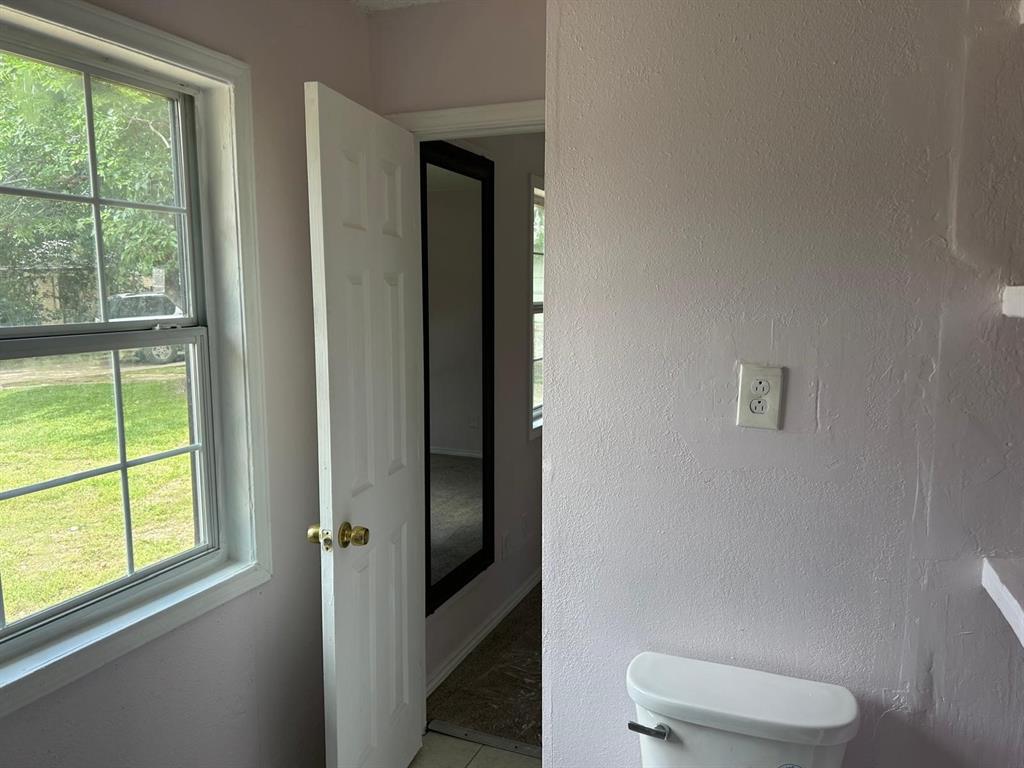 10034 Mill Valley Lane Dallas, TX 75217 - Photo 18 of 18 a bathroom with a toilet