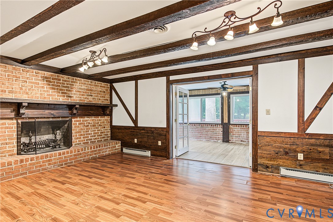 13310 Gladehill Road Chester, VA 23831 - Photo 21 of 41 Brick fireplace with a wooden mantel and hearth