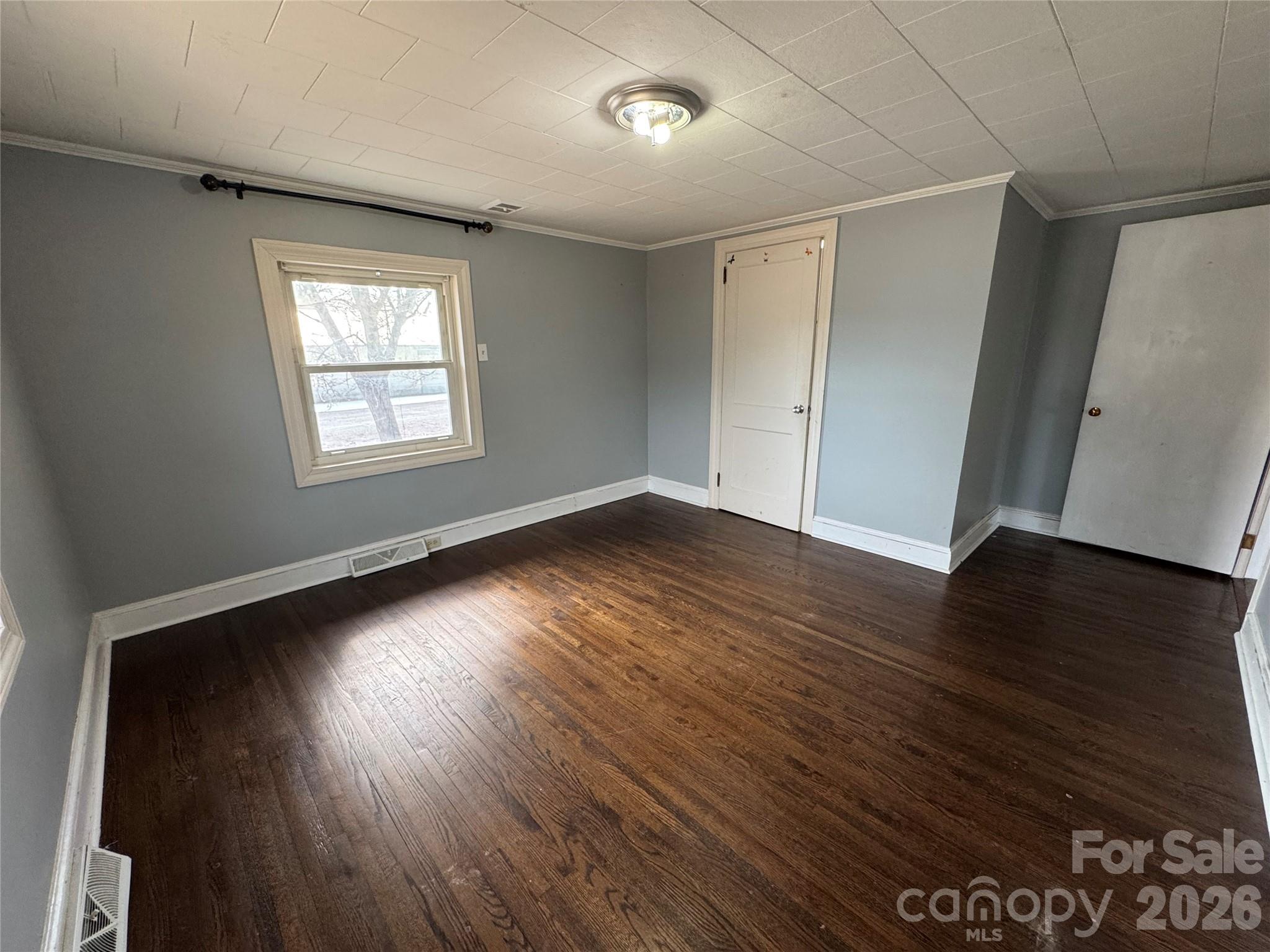 545 Collins Street Kannapolis, NC 28083 - Photo 14 of 27 an empty room with wooden floor and windows