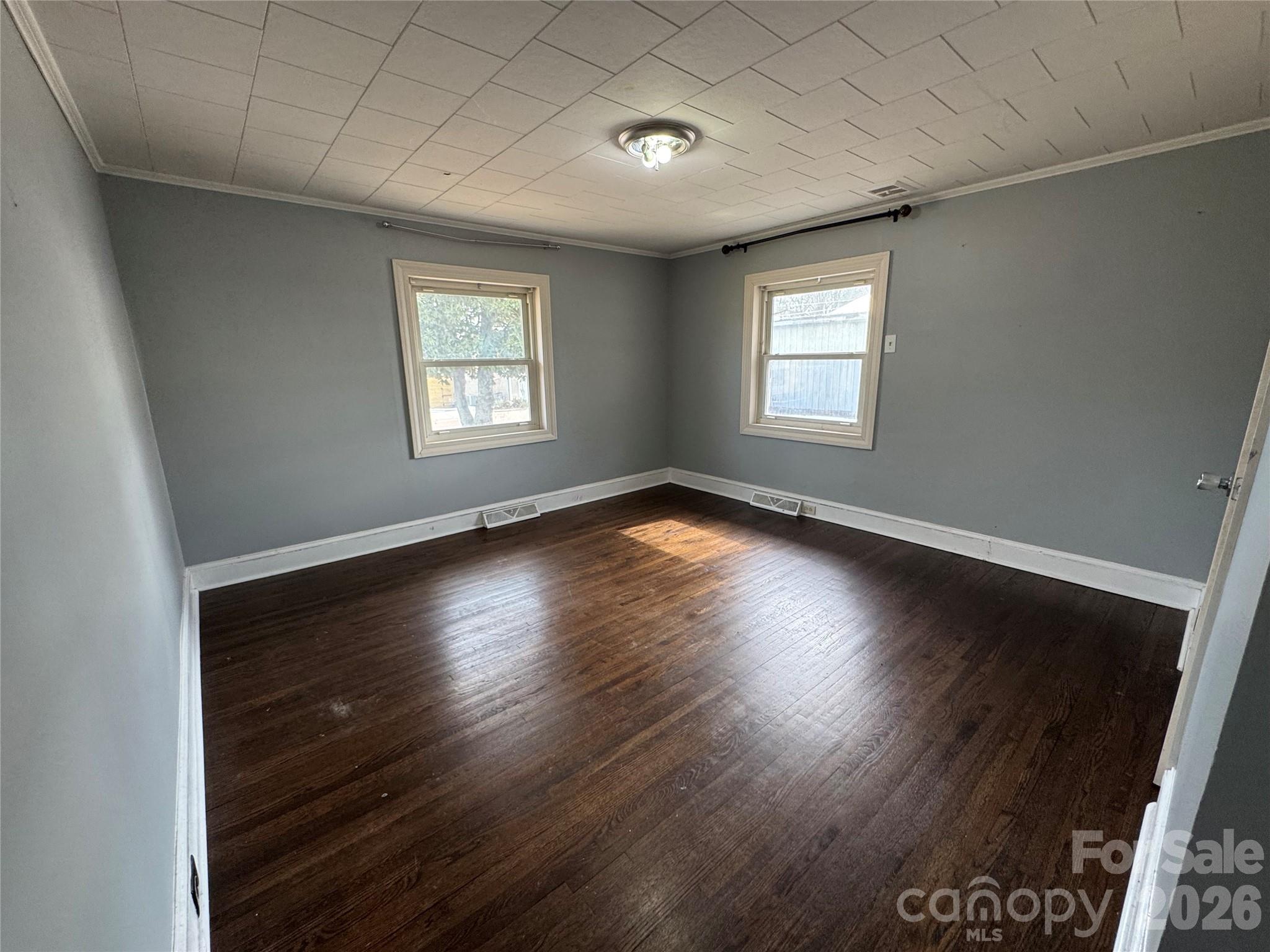 545 Collins Street Kannapolis, NC 28083 - Photo 15 of 27 an empty room with wooden floor and windows