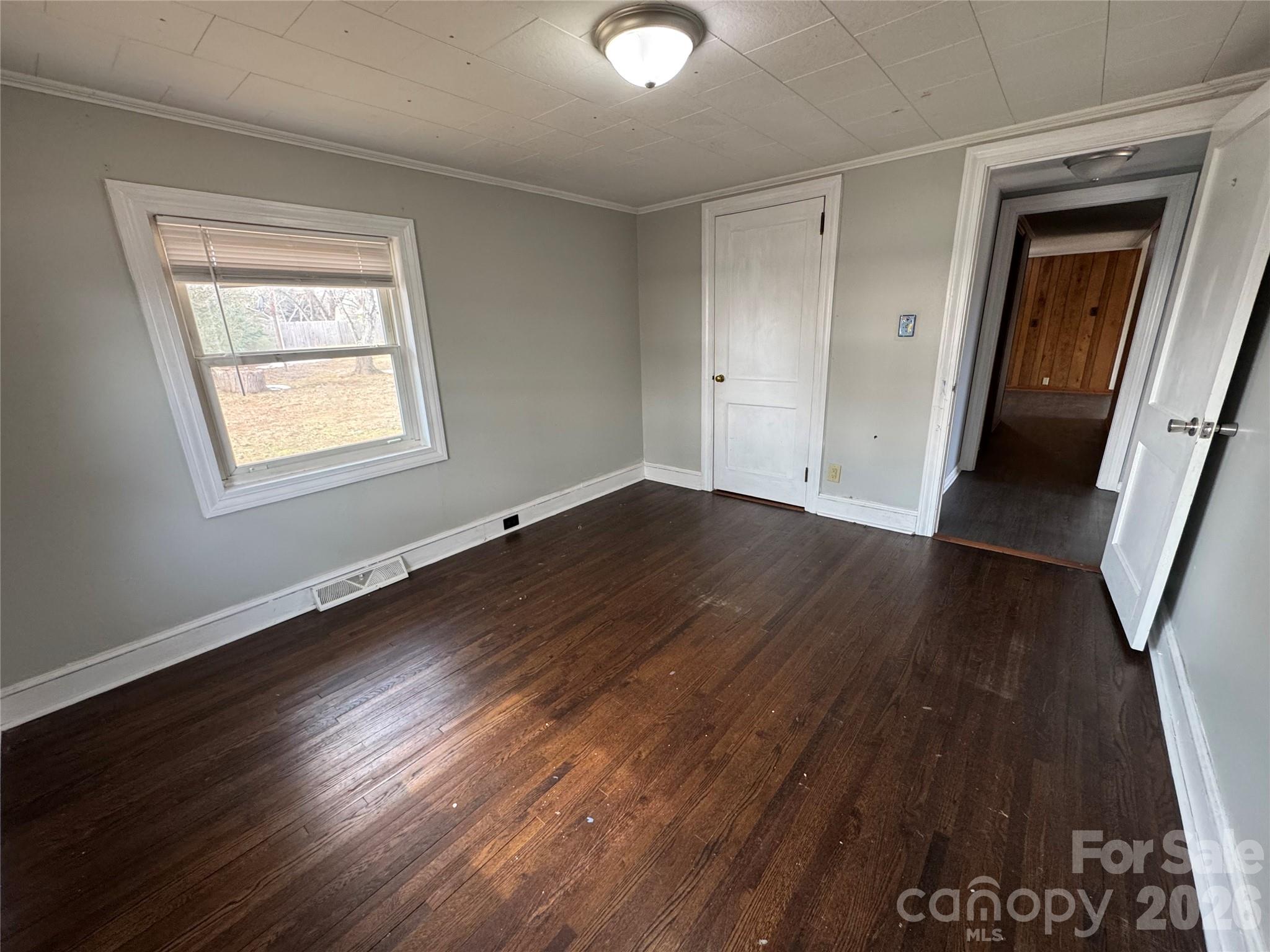 545 Collins Street Kannapolis, NC 28083 - Photo 17 of 27 a view of an empty room with wooden floor and a window