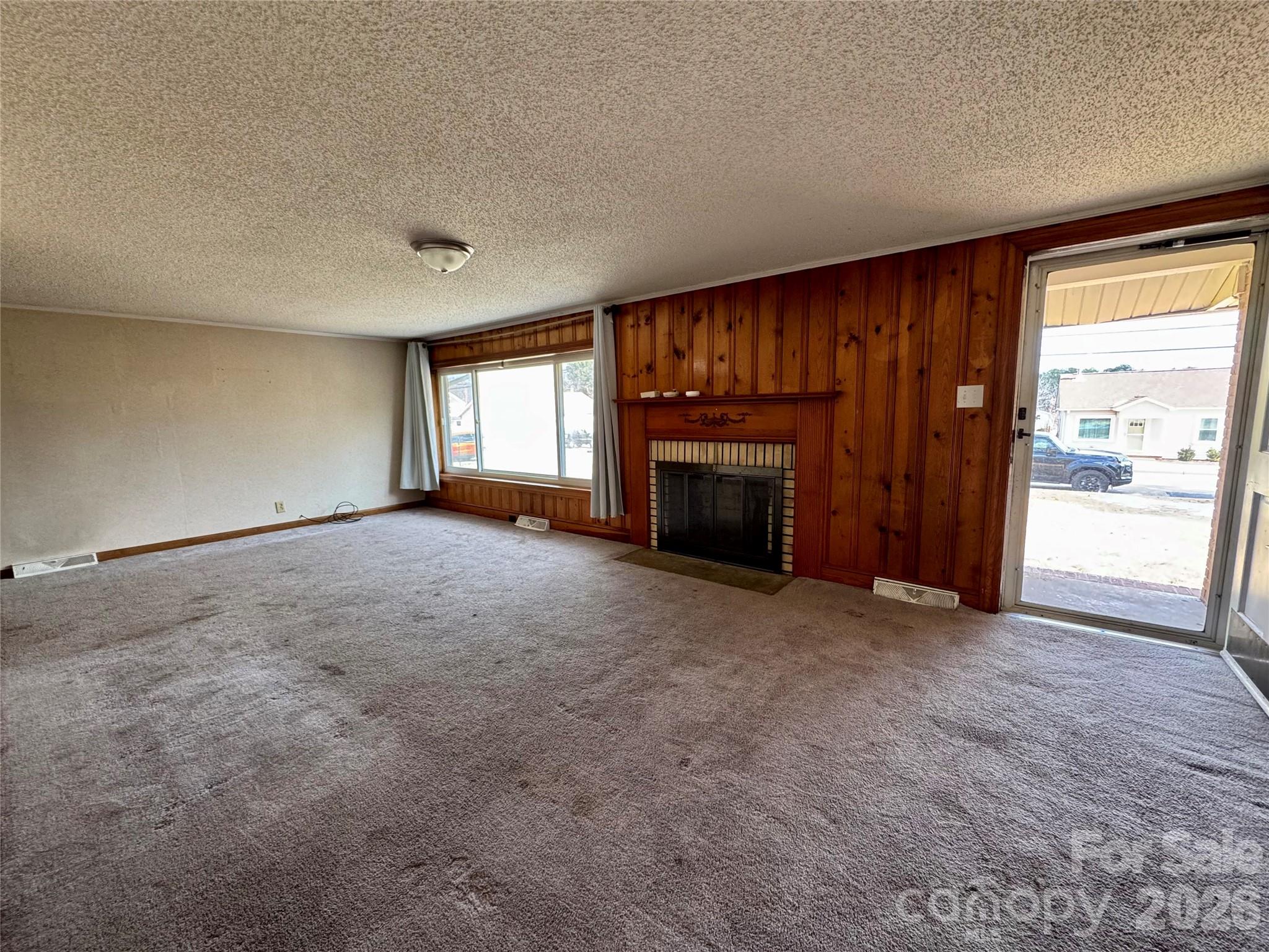 545 Collins Street Kannapolis, NC 28083 - Photo 2 of 27 an empty room with furniture and a fireplace