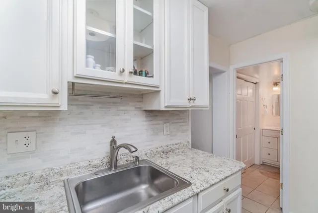 a kitchen with stainless steel appliances granite countertop a sink and a stove