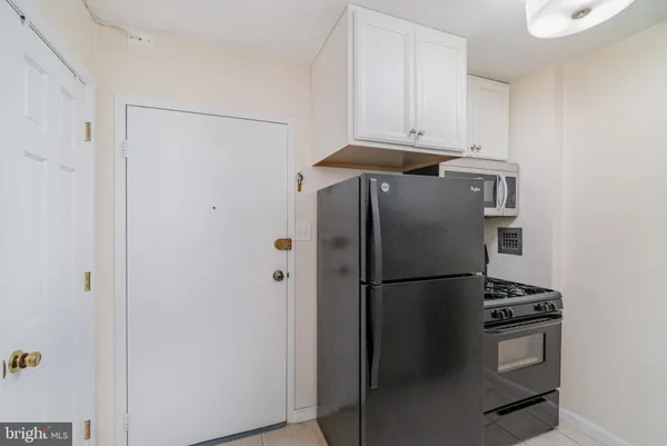a kitchen with granite countertop a sink and a stove