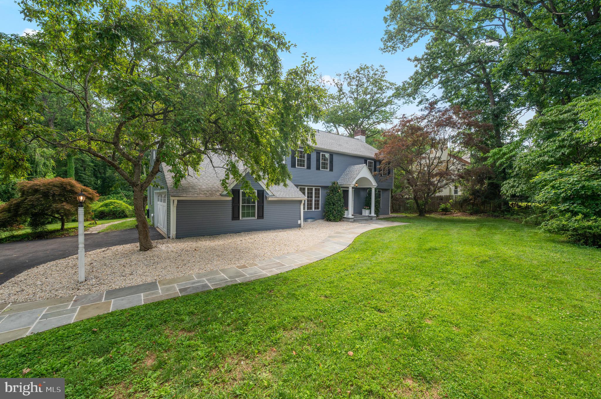 813 Malin Road Newtown Square, PA 19073 - Photo 3 of 55 a front view of a house with a yard and garage