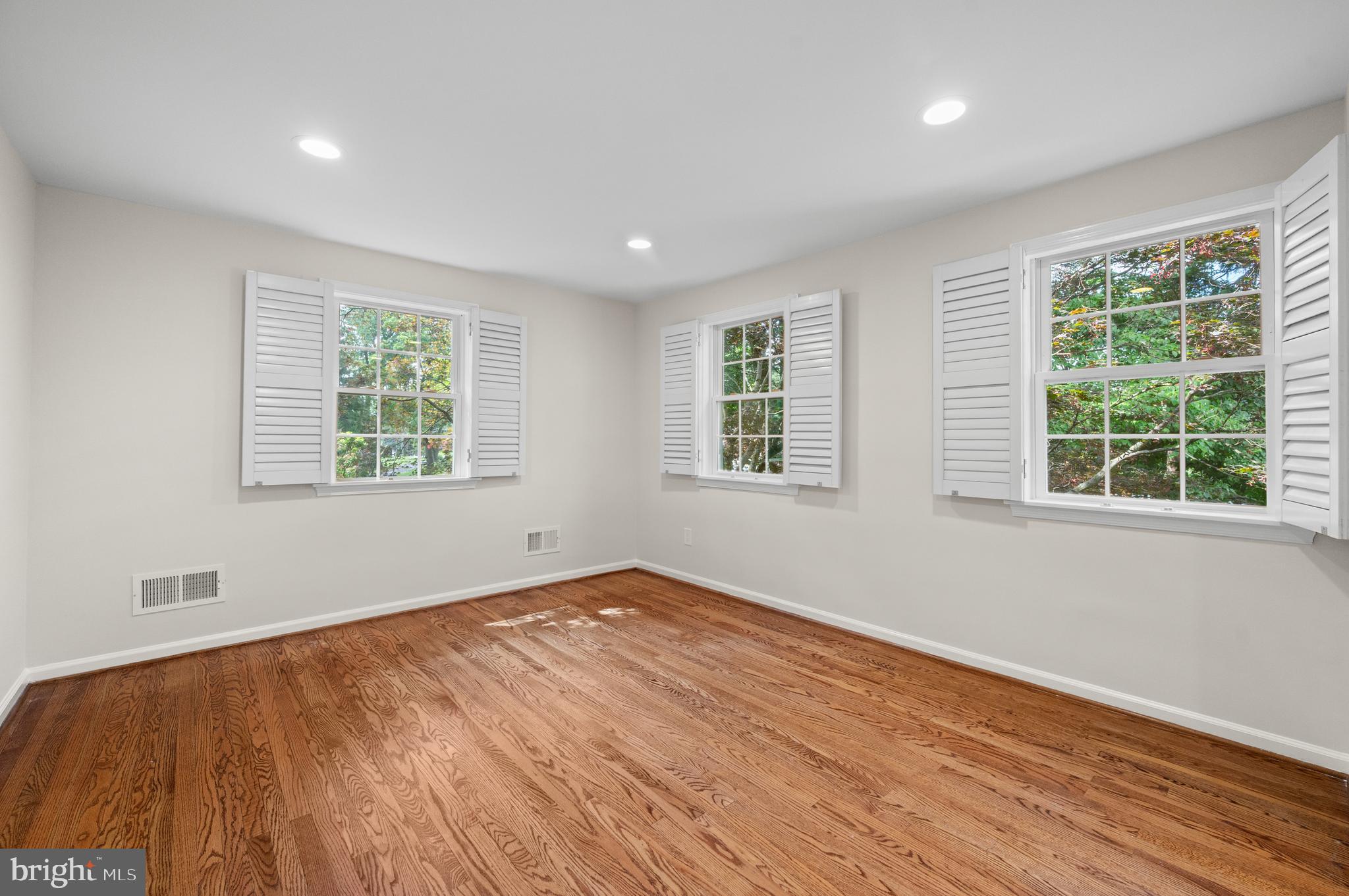 813 Malin Road Newtown Square, PA 19073 - Photo 41 of 55 a view of an empty room with wooden floor and a window