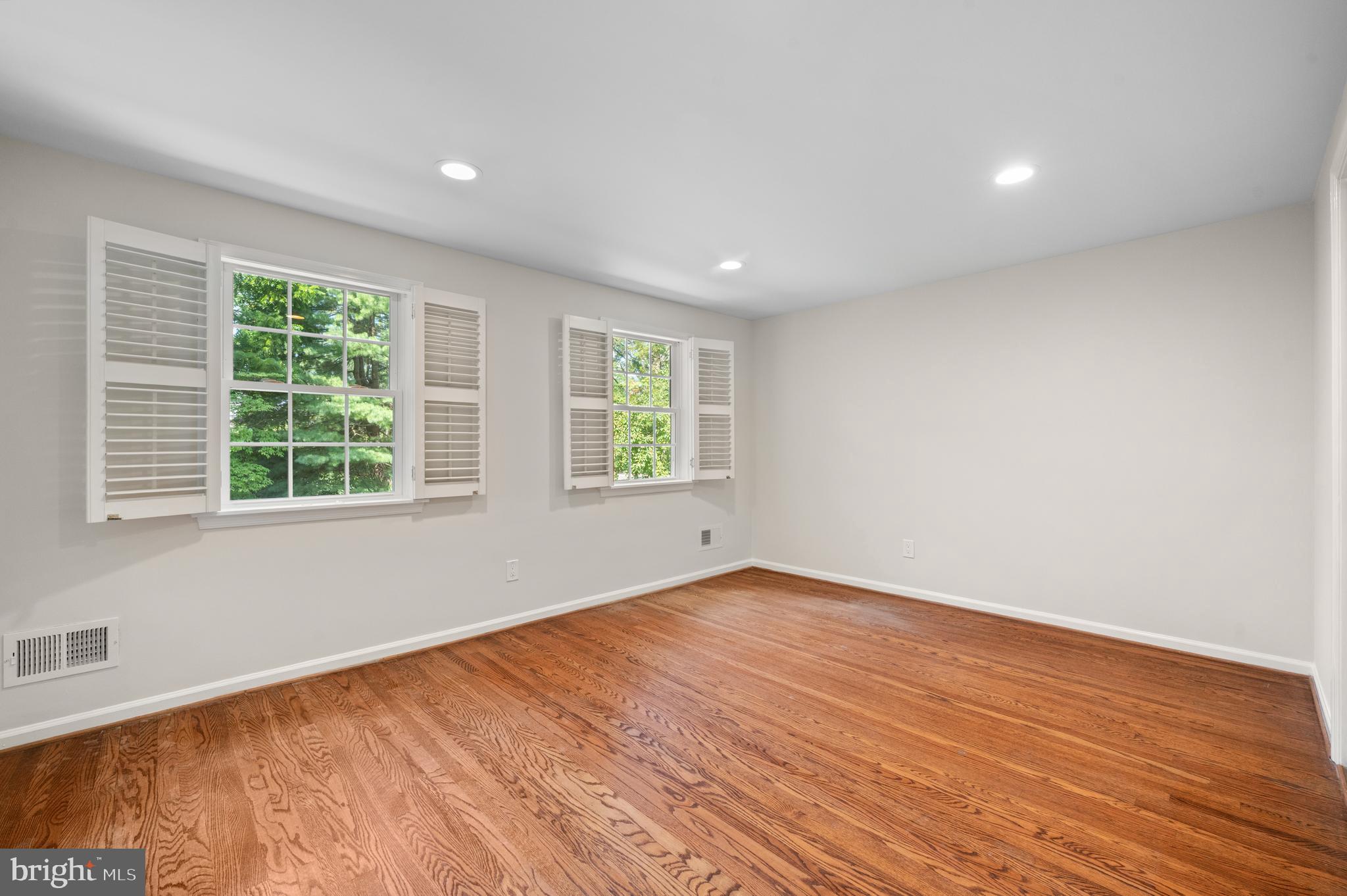 813 Malin Road Newtown Square, PA 19073 - Photo 42 of 55 a view of an empty room with wooden floor and a window