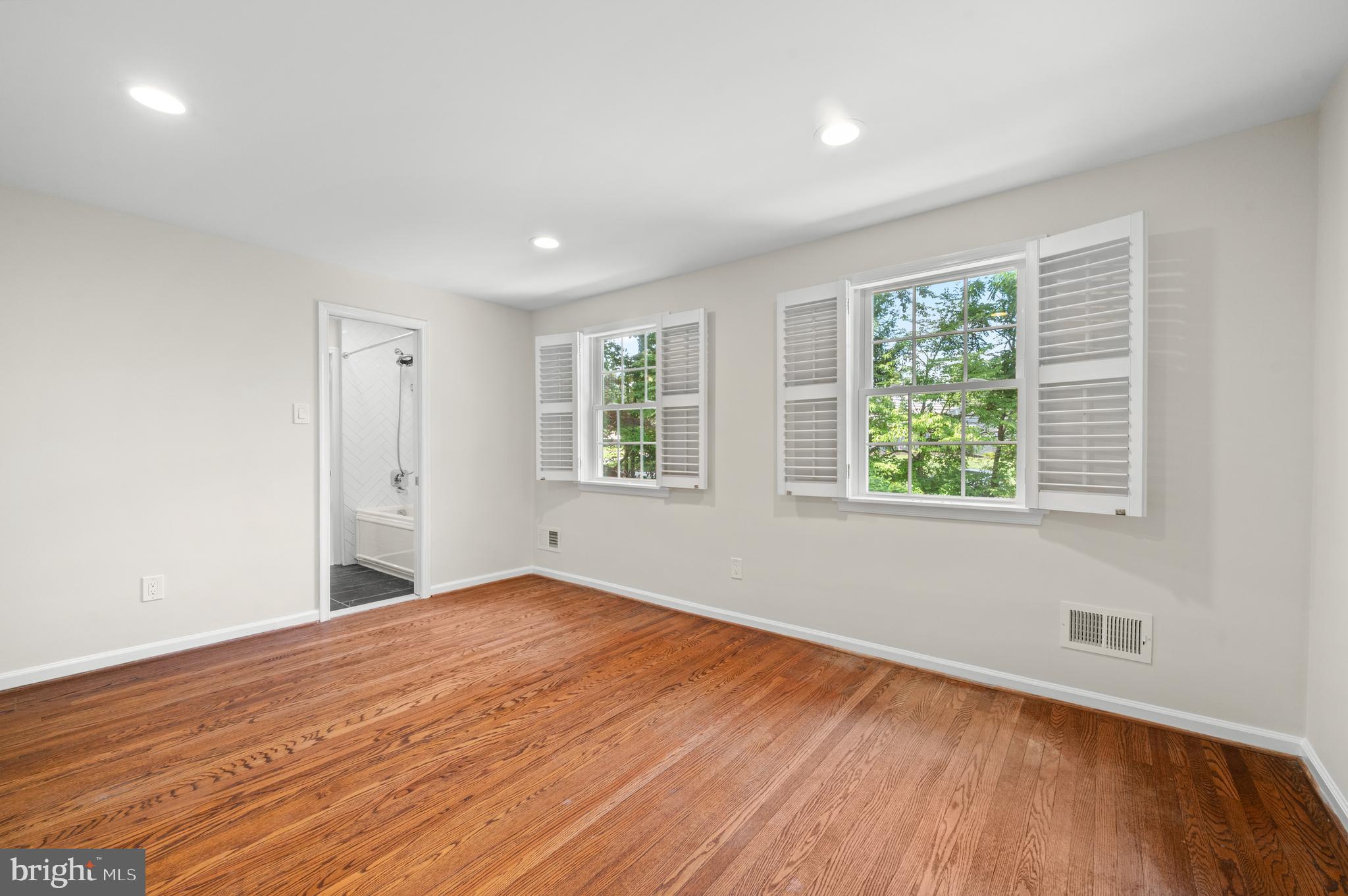 813 Malin Road Newtown Square, PA 19073 - Photo 43 of 55 a view of an empty room with wooden floor and a window