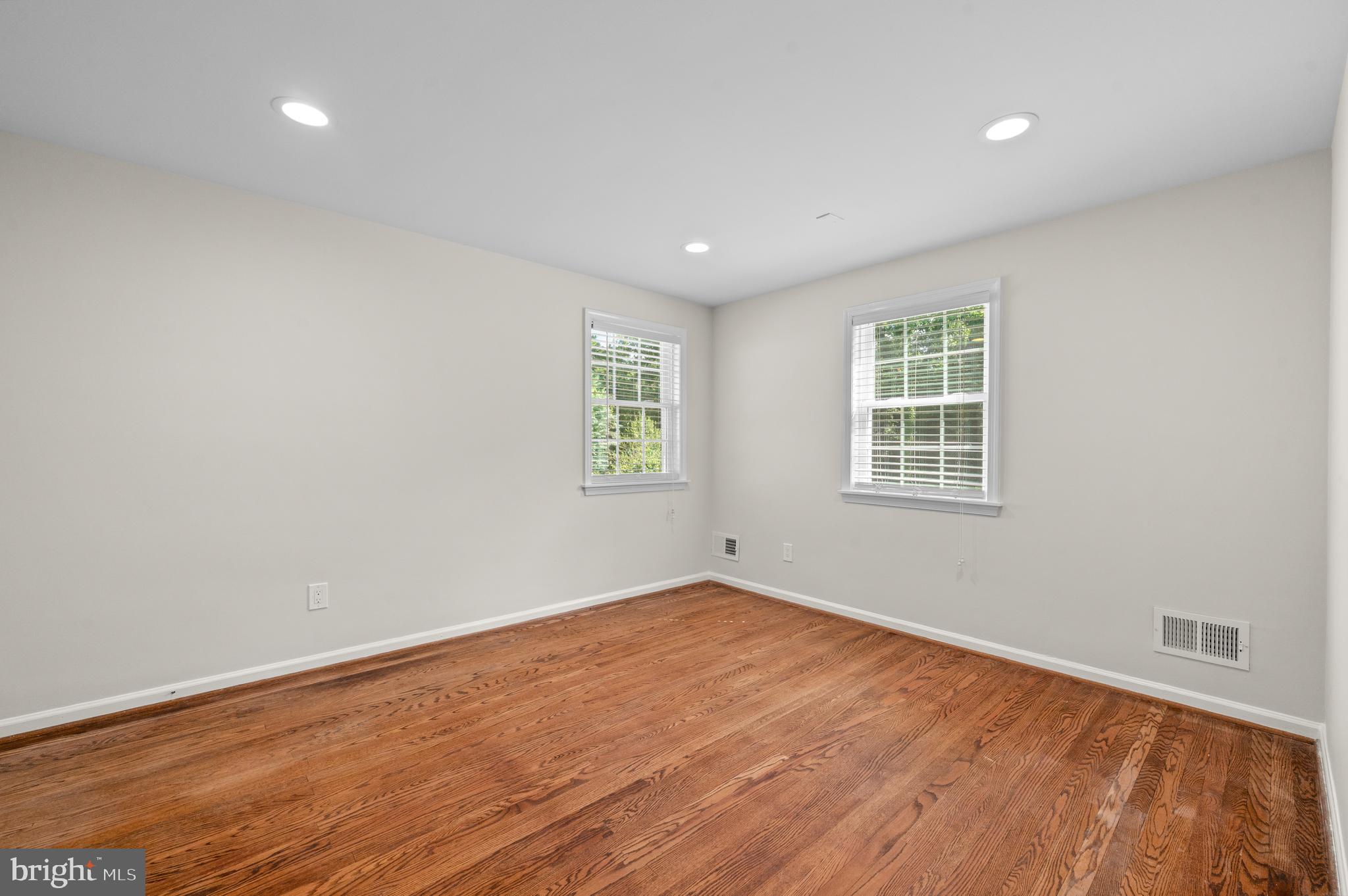 813 Malin Road Newtown Square, PA 19073 - Photo 44 of 55 an empty room with wooden floor and windows